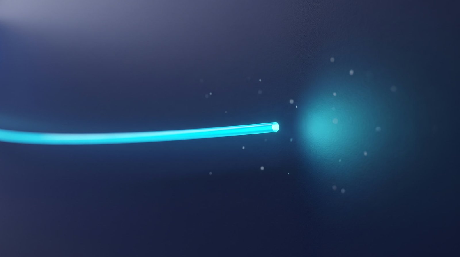 A soft cyan glow arriving at the end of a fibre strand, the install